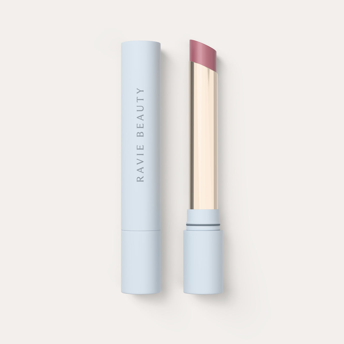 An open tube beside its cap. Ravie Beauty Effortless Lips™ Sheer-Buildable Lip Color in Dahlia #color_dahlia