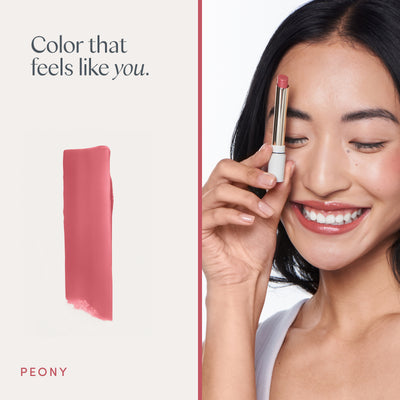 Color that feels like you. A model wearing it, and a swipe of the color. Ravie Beauty Effortless Lips™ Sheer-Buildable Lip Color in Peony 