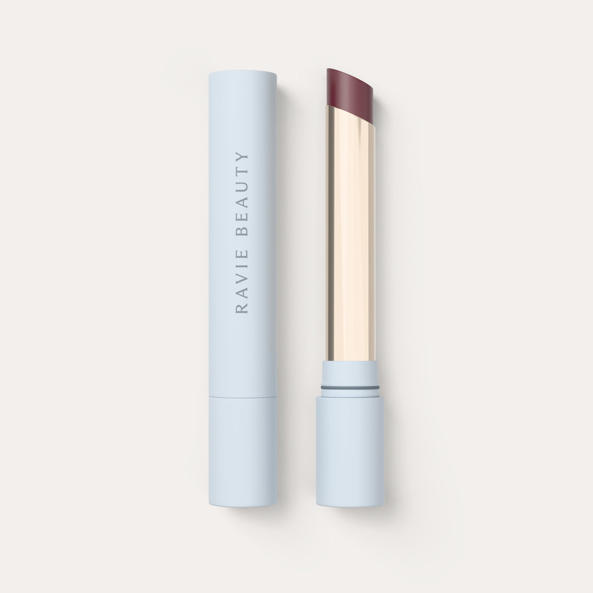 An open tube beside its cap. Ravie Beauty Effortless Lips™ Sheer-Buildable Lip Color in Verbena 