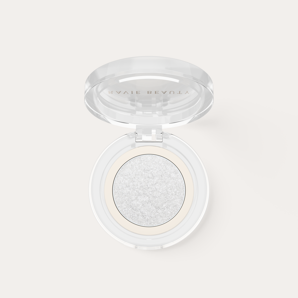An open compact. Ravie Beauty Softlight™ Glistening Eye Topper in Soft Pearl 