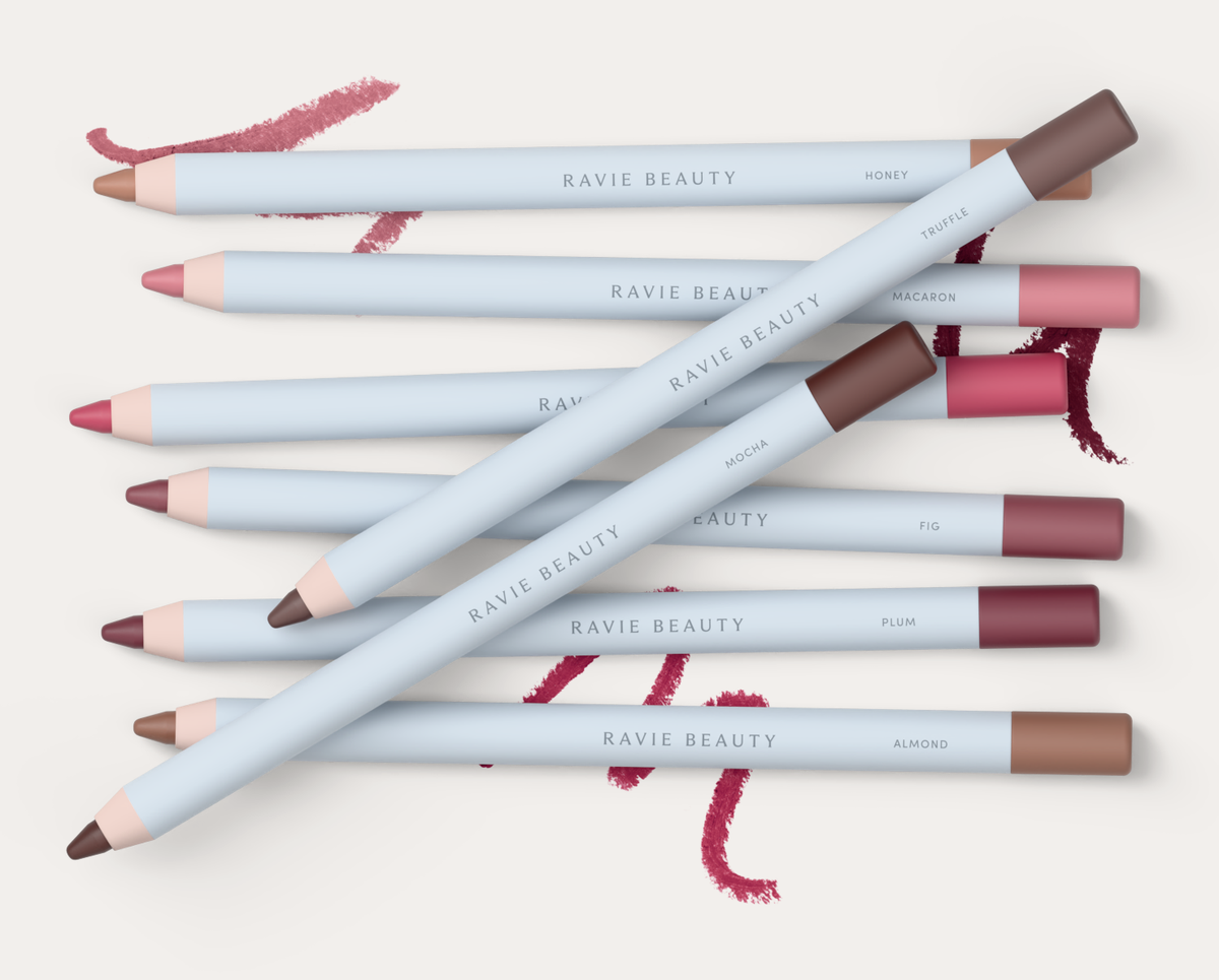 All eight shades together, with swatches behind: Macaron, Honey, Strawberry, Almond, Fig, Truffle, Plum and Mocha. Ravie Beauty Soft Definition™ Longwear Lip Liner
